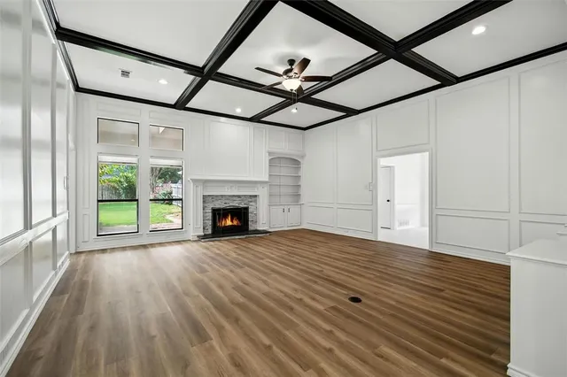 a view of an empty room and window and a kitchen