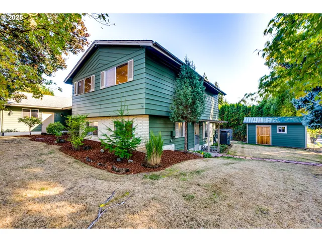 a front view of a house with a garden