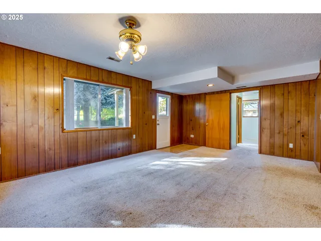 a view of empty room with wooden walls