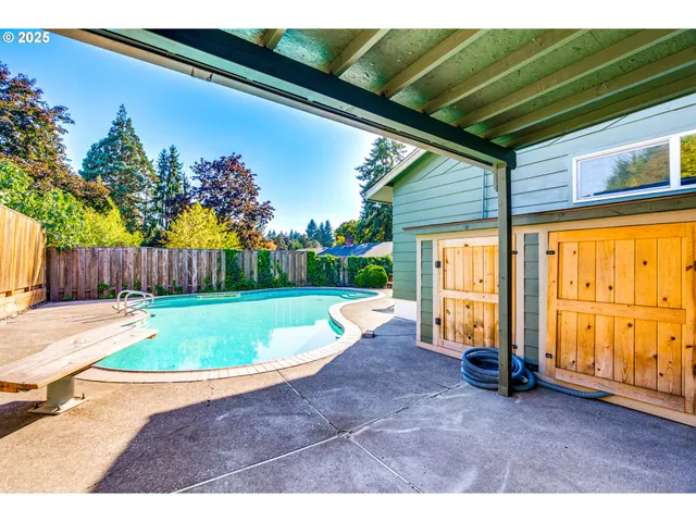 a view of swimming pool with a lounge chairs