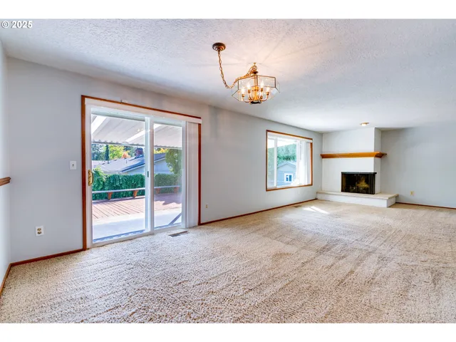 a view of empty room with a fireplace