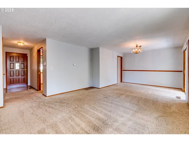 a kitchen with a sink window and cabinets