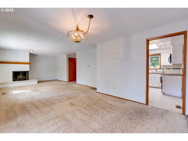 a kitchen with stainless steel appliances granite countertop a sink a stove a microwave and wooden cabinets