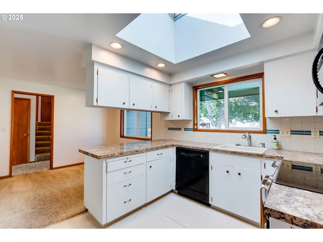 a kitchen with a stove a sink and a microwave