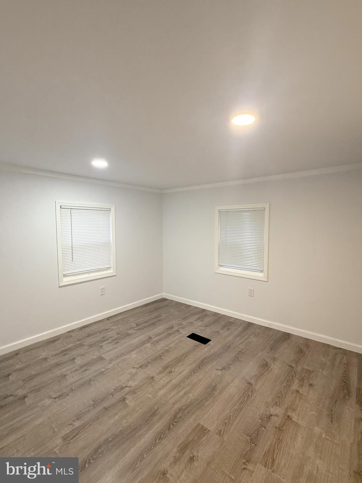 3638 Weymouth Road Browns Mills, NJ 08015 - Photo 8 of 14 an empty room with wooden floor and windows