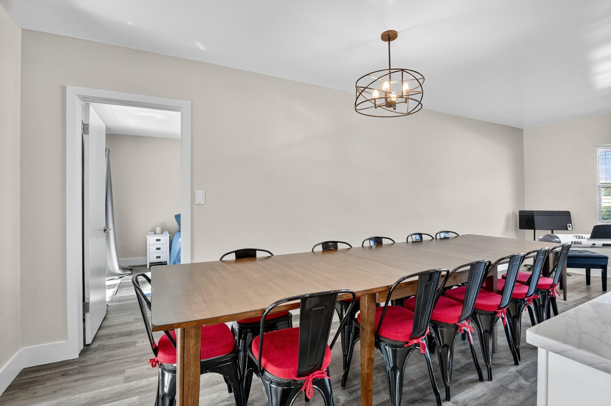 1650 Northwest 9th Street Boca Raton, FL 33486 - Photo 12 of 57 a view of a dining room with furniture wooden floor and chandelier