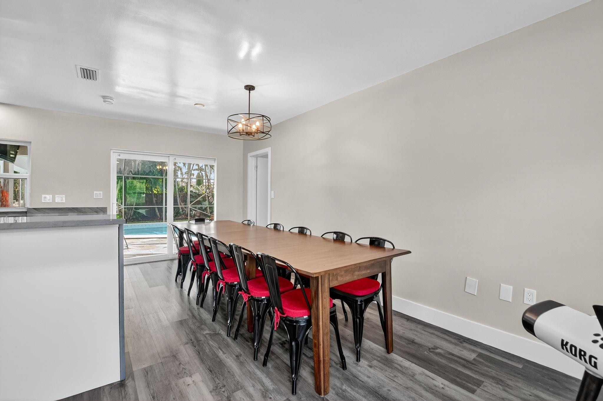1650 Northwest 9th Street Boca Raton, FL 33486 - Photo 14 of 57 a living room with furniture a chandelier and a dining table