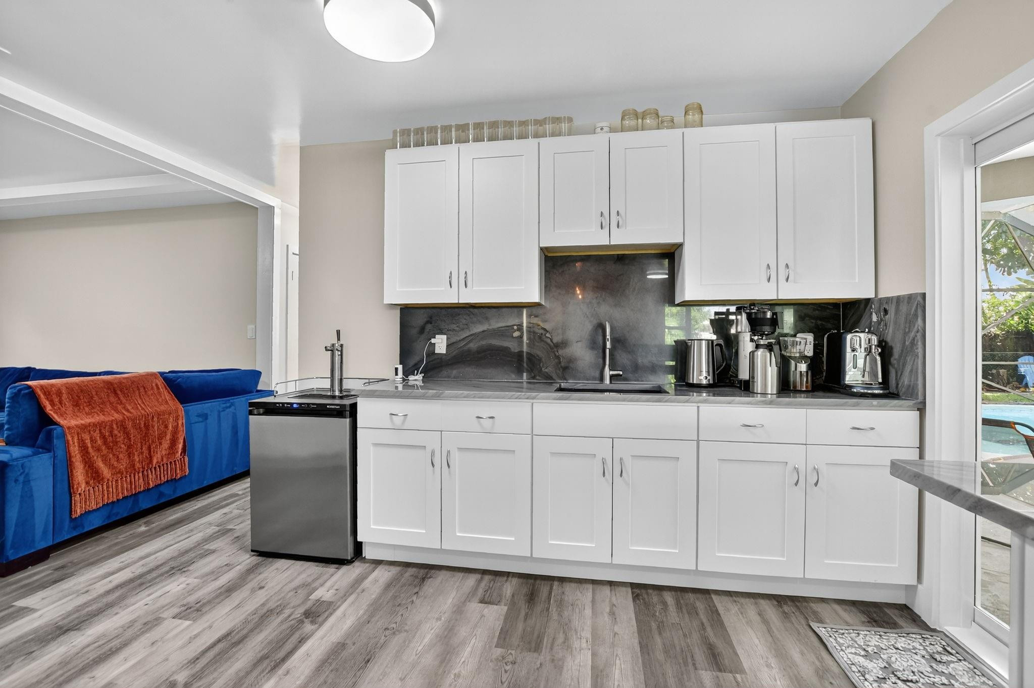 1650 Northwest 9th Street Boca Raton, FL 33486 - Photo 18 of 57 a kitchen with stainless steel appliances granite countertop a stove a sink and white cabinets