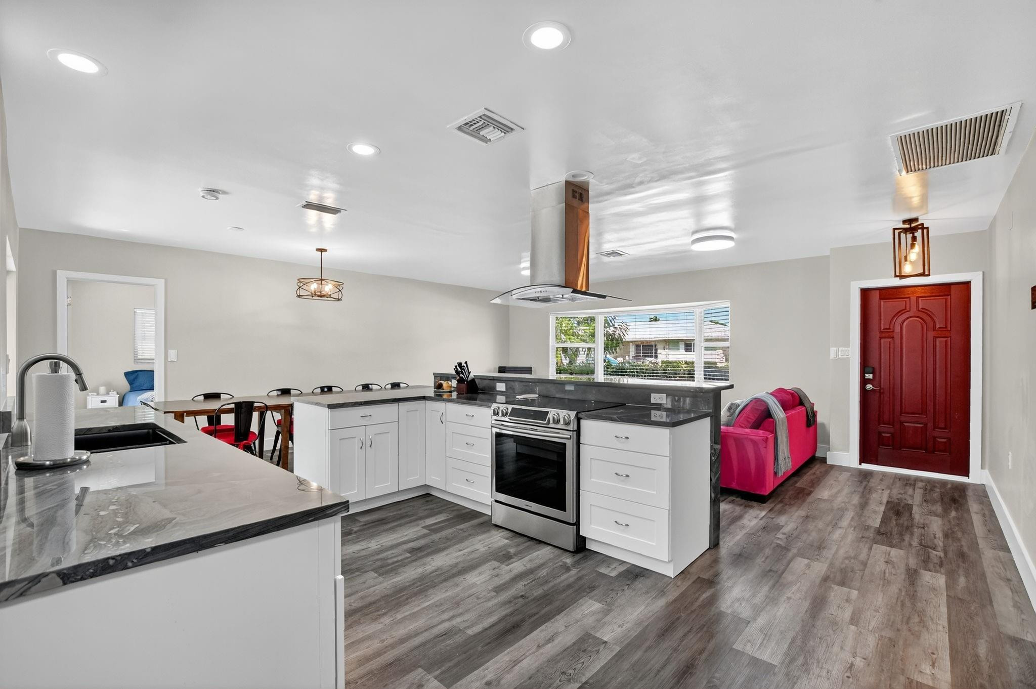 1650 Northwest 9th Street Boca Raton, FL 33486 - Photo 3 of 57 a kitchen with a sink and a stove top oven