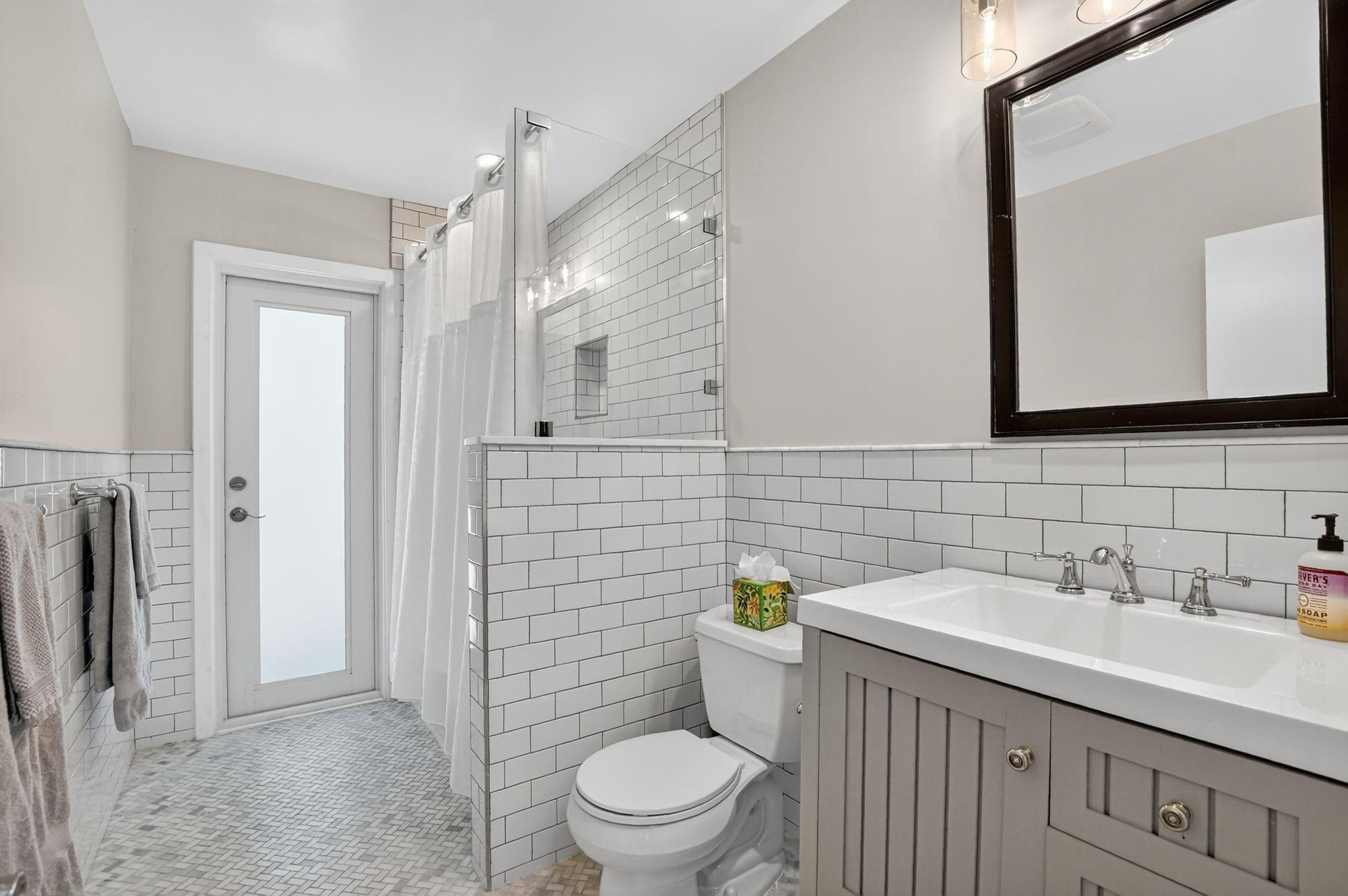 1650 Northwest 9th Street Boca Raton, FL 33486 - Photo 34 of 57 a bathroom with a sink a toilet and a mirror