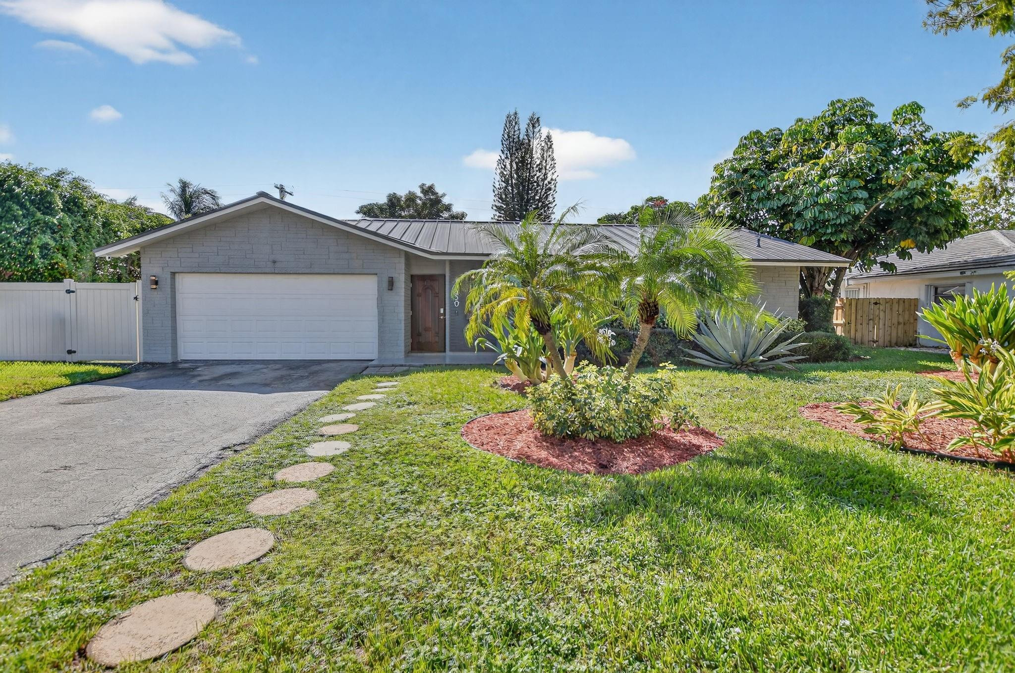 1650 Northwest 9th Street Boca Raton, FL 33486 - Photo 43 of 57 a front view of a house with a yard and fountain