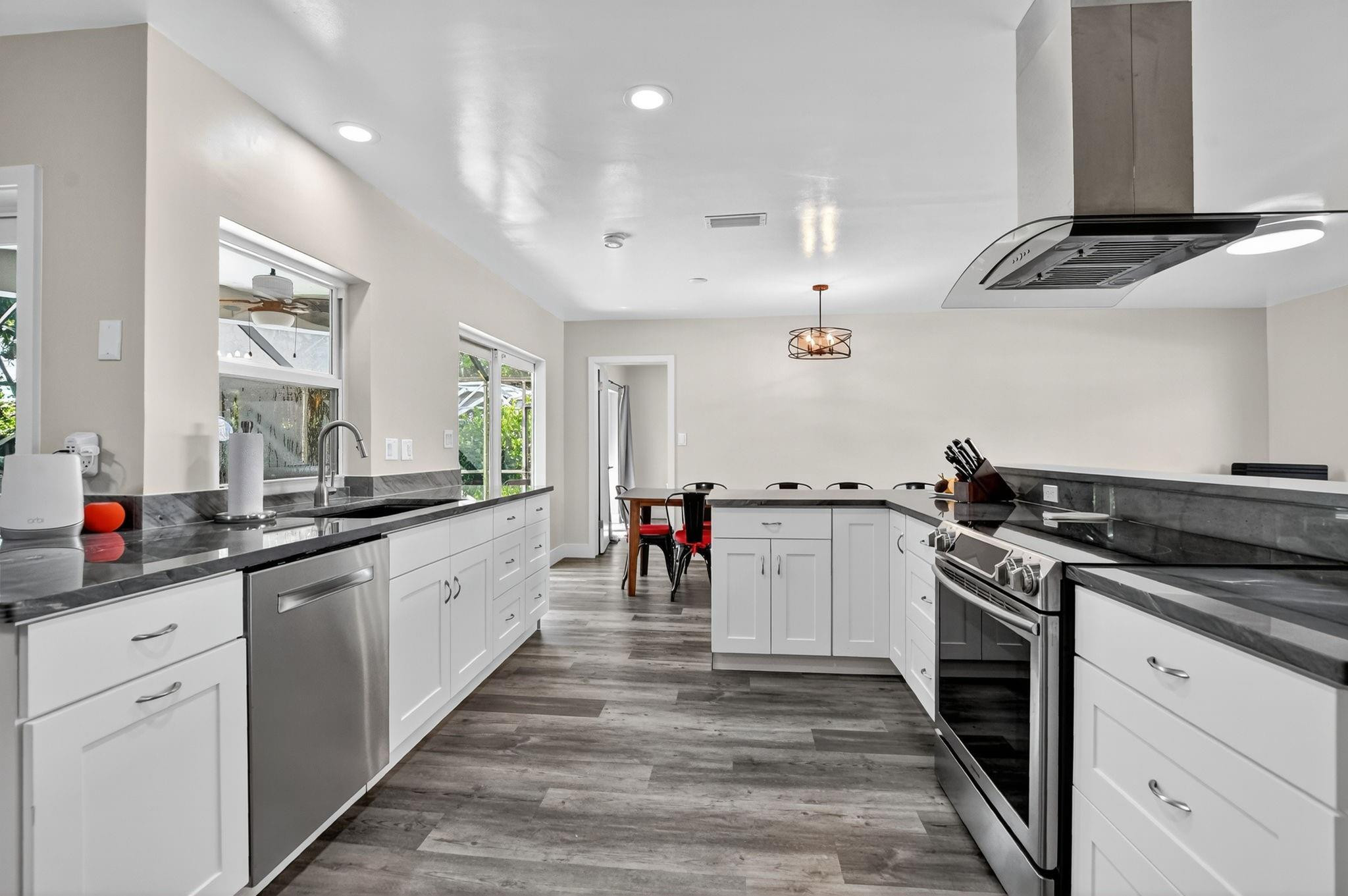 1650 Northwest 9th Street Boca Raton, FL 33486 - Photo 7 of 57 a kitchen with stainless steel appliances granite countertop a sink and cabinets
