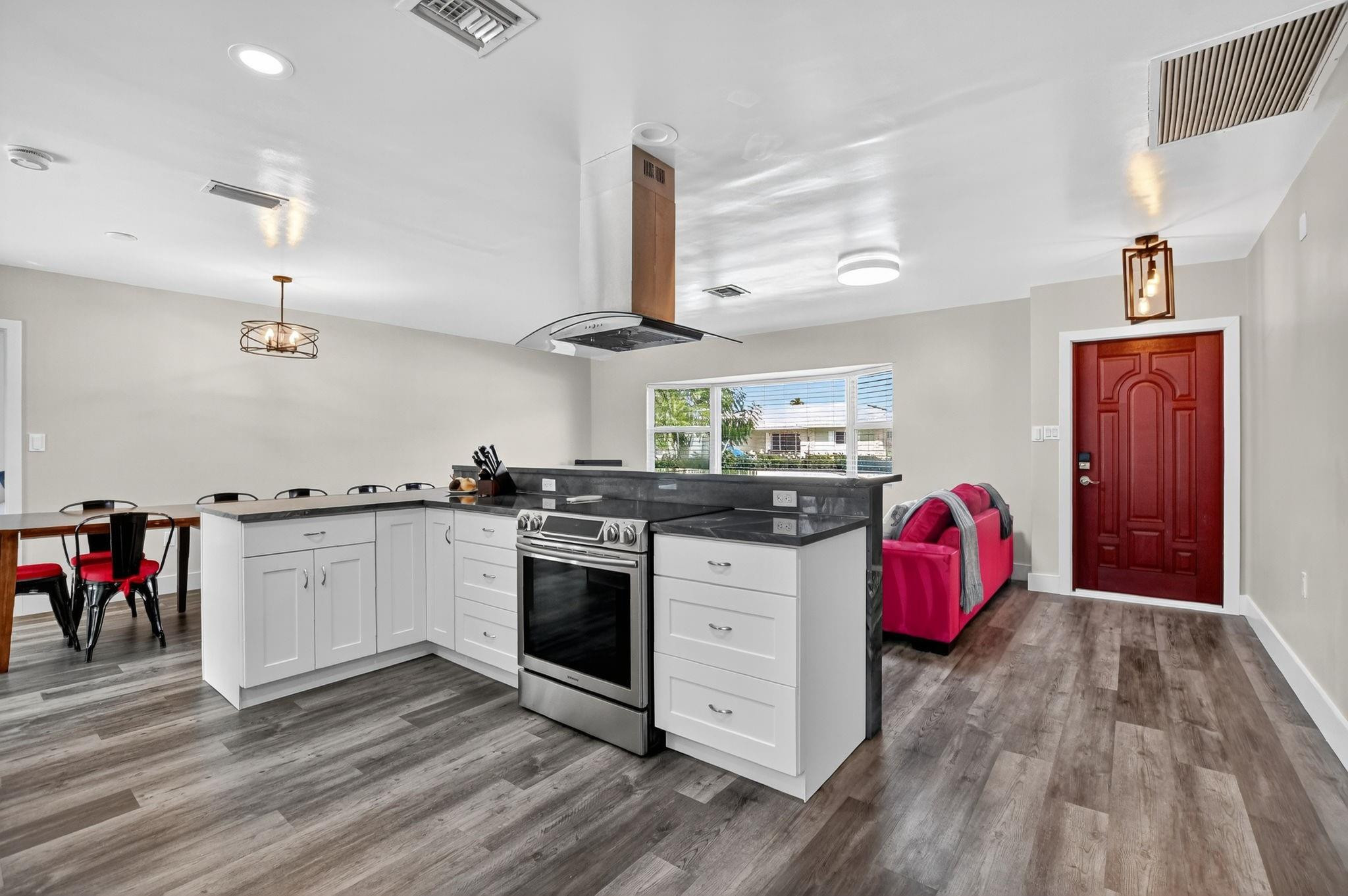 1650 Northwest 9th Street Boca Raton, FL 33486 - Photo 8 of 57 a kitchen with granite countertop a stove and wooden floor
