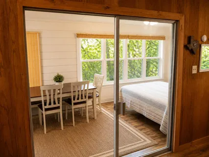 a dining room with furniture and window