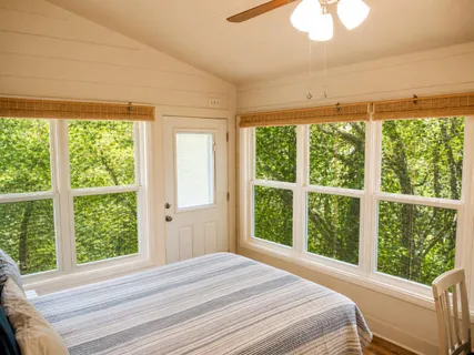 a view of a bedroom with a large window