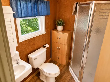 a white toilet sitting next to a sink