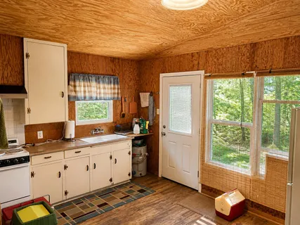 a kitchen with a sink window and cabinets