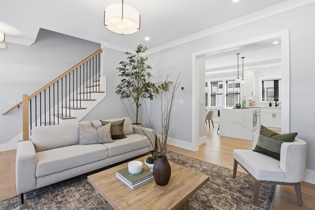 10 Webber Avenue, Unit 101 Bedford, MA 01730 - Photo 12 of 35 a living room with furniture flowerpot and wooden floor