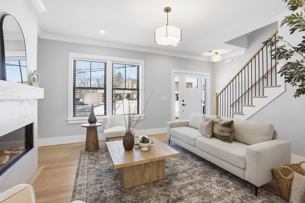 10 Webber Avenue, Unit 101 Bedford, MA 01730 - Photo 13 of 35 a living room with fireplace furniture and a wooden floor