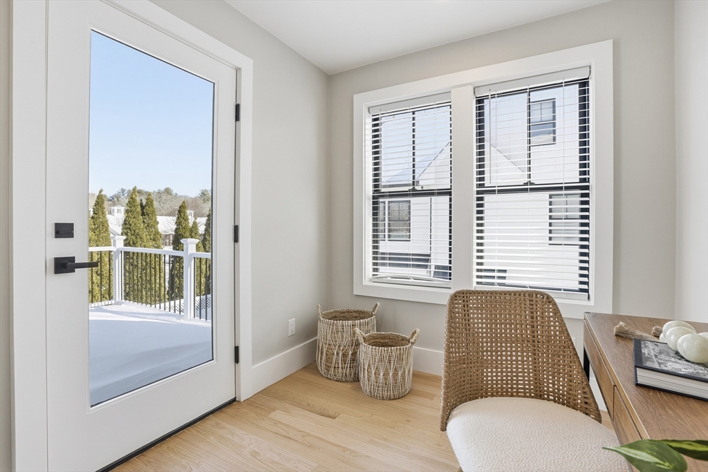 10 Webber Avenue, Unit 101 Bedford, MA 01730 - Photo 20 of 35 a living room with furniture and windows