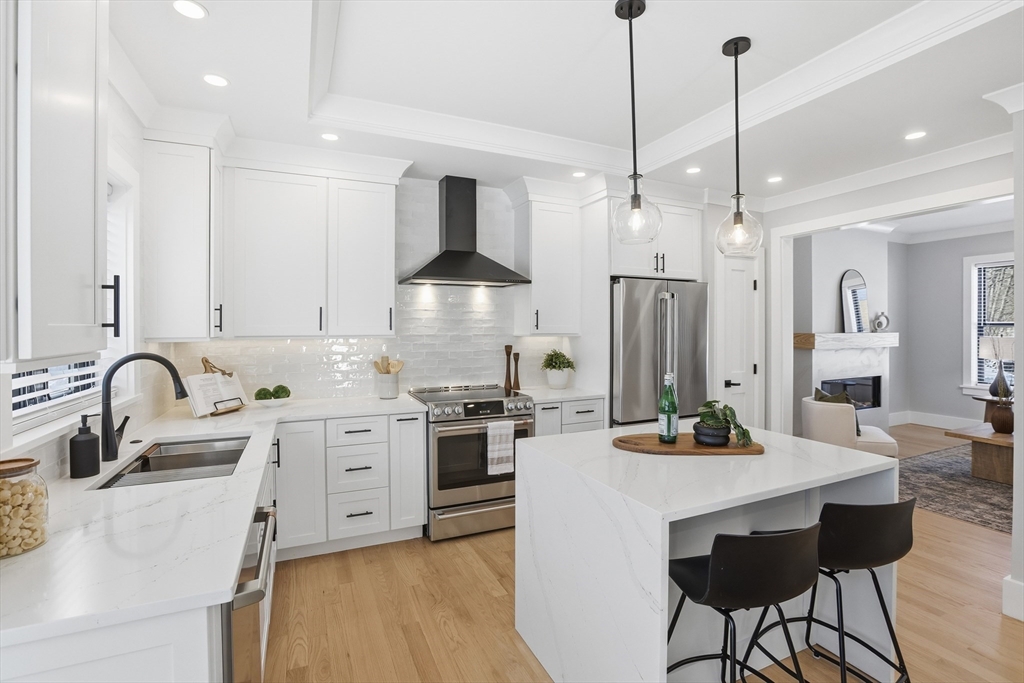 10 Webber Avenue, Unit 101 Bedford, MA 01730 - Photo 2 of 35 a kitchen with stainless steel appliances a sink stove and refrigerator