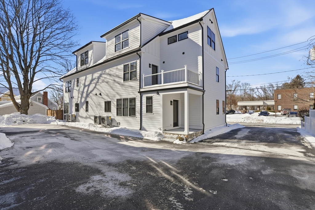 10 Webber Avenue, Unit 101 Bedford, MA 01730 - Photo 32 of 35 a view of a house with a yard covered in snow