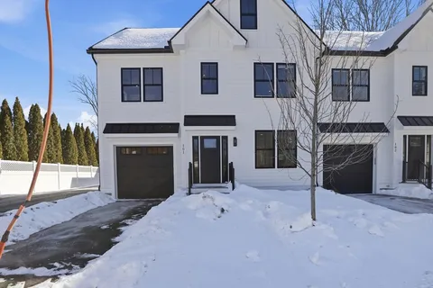 a view of a big house with pool and chairs