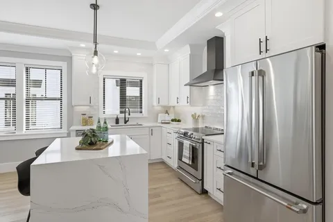 a kitchen with stainless steel appliances sink stove refrigerator and microwave