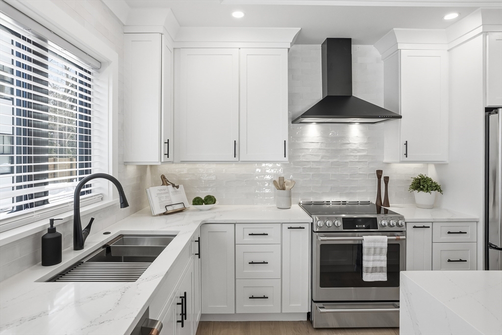 10 Webber Avenue, Unit 101 Bedford, MA 01730 - Photo 7 of 35 a kitchen with stainless steel appliances a sink stove and cabinets
