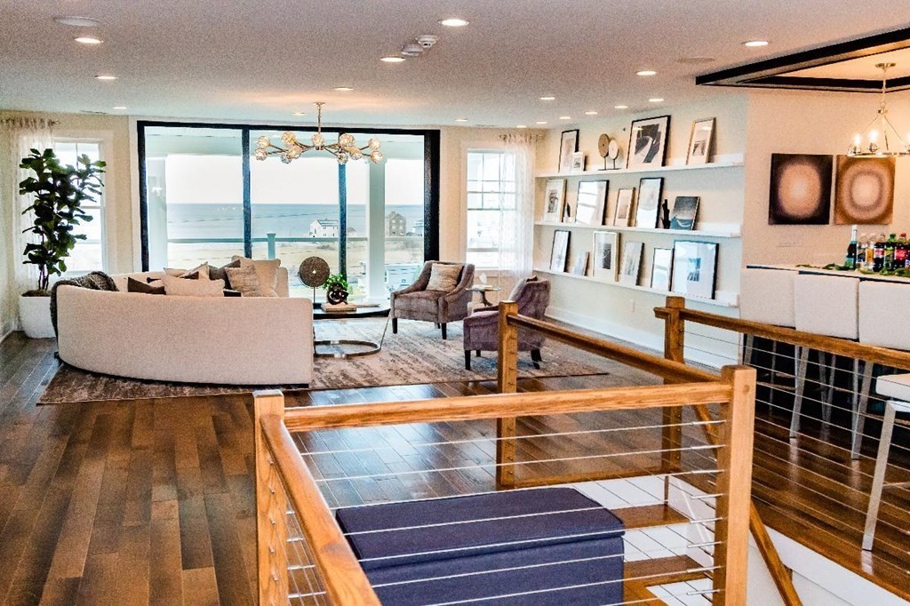 162 Hatherly Road, Unit 157 Scituate, MA 02066 - Photo 9 of 15 a living room with furniture and a floor to ceiling window