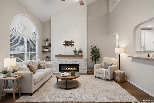 a living room with furniture and a fireplace