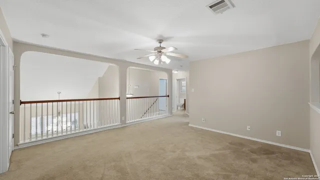 a view of a livingroom with a ceiling fan and window