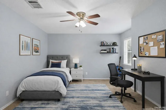 a bedroom with a bed and a desk