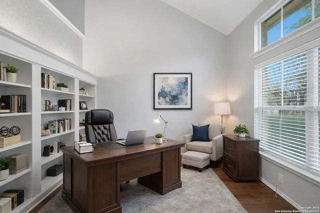 a living room with furniture and a book shelf