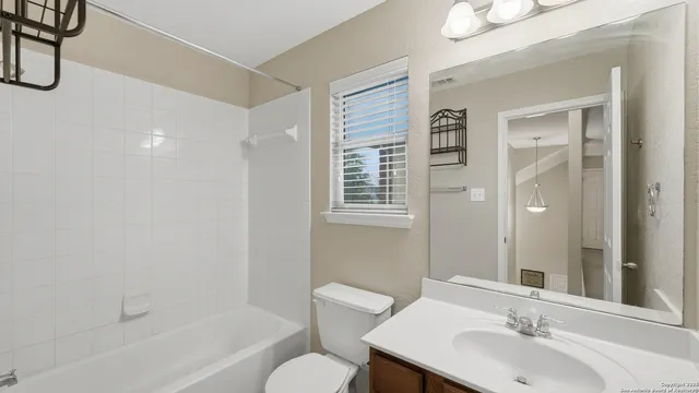 a bathroom with a bathtub shower sink and a toilet
