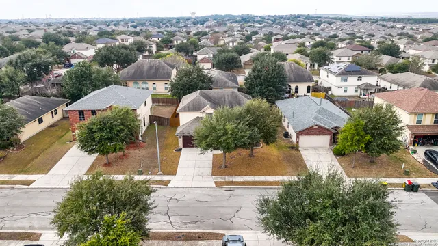 an aerial view of residential houses with outdoor space