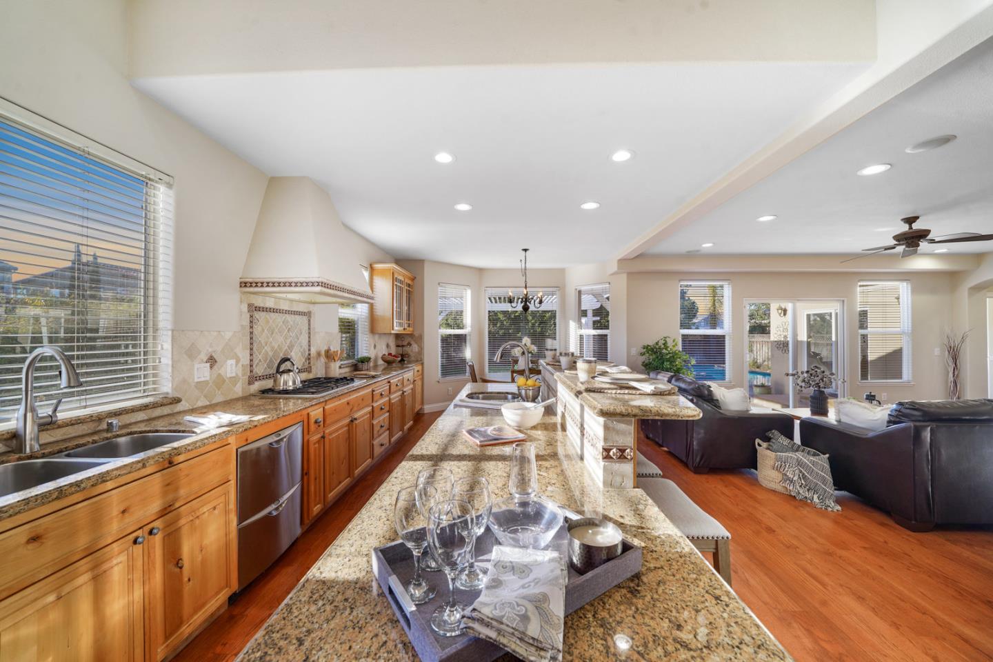 761 Dakota Drive Morgan Hill, CA 95037 - Photo 6 of 32 a large living room with stainless steel appliances granite countertop a couch and a large window