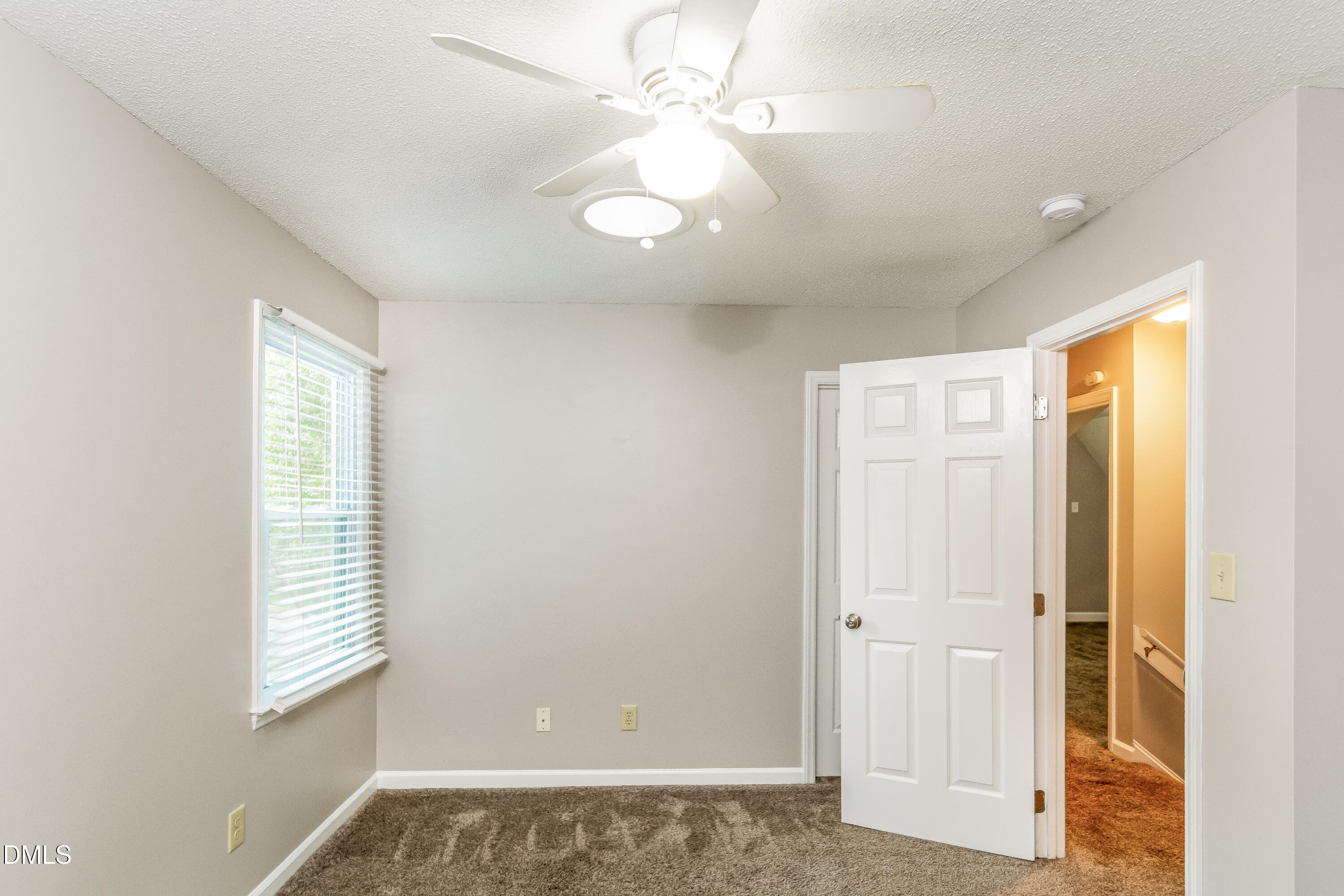 405 Hunters Ridge Drive Fuquay-Varina, NC 27526 - Photo 12 of 17 a view of an empty room with window and chandelier fan