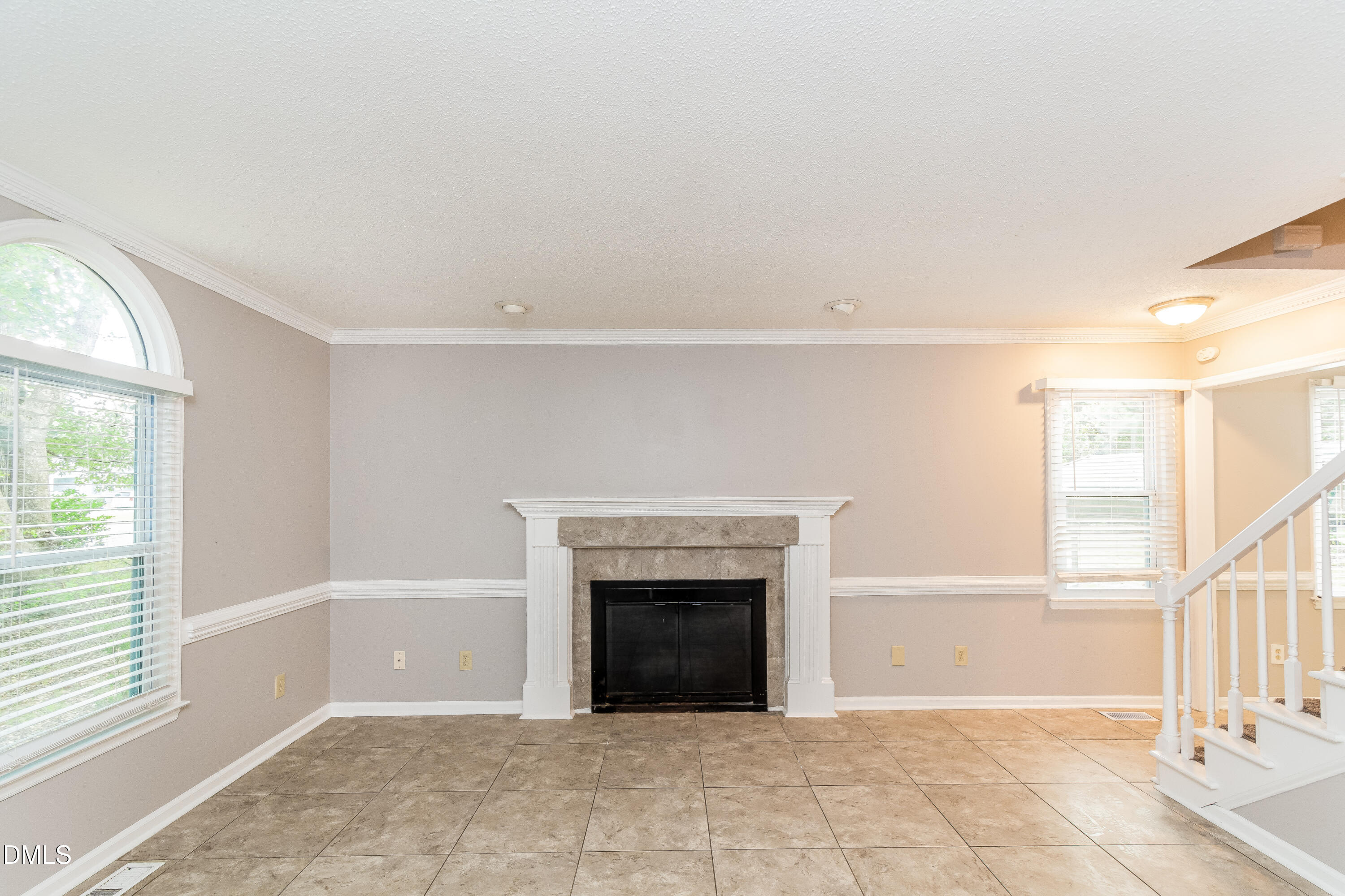 405 Hunters Ridge Drive Fuquay-Varina, NC 27526 - Photo 3 of 17 a view of an empty room with a fireplace and a window