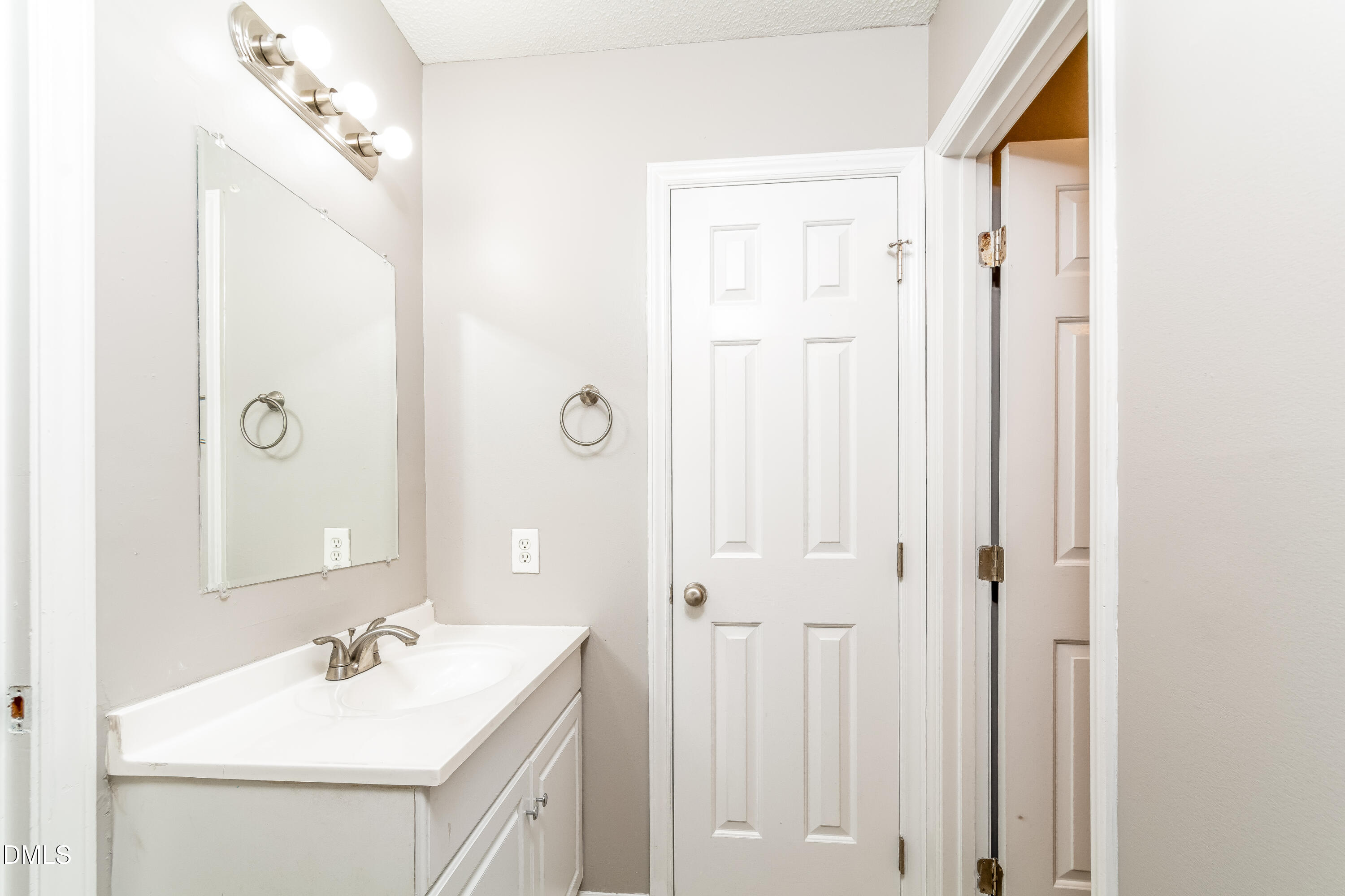 405 Hunters Ridge Drive Fuquay-Varina, NC 27526 - Photo 8 of 17 a bathroom with a sink vanity and a mirror
