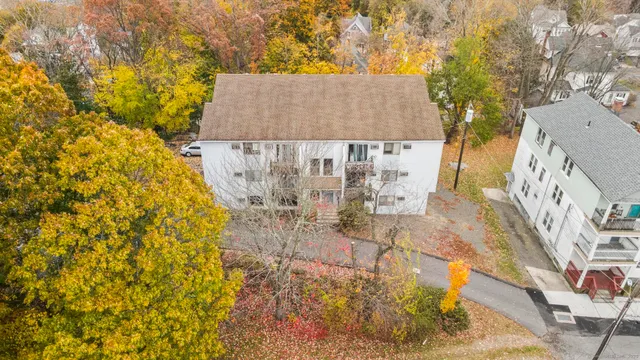 an aerial view of a house with a yard and sitting area