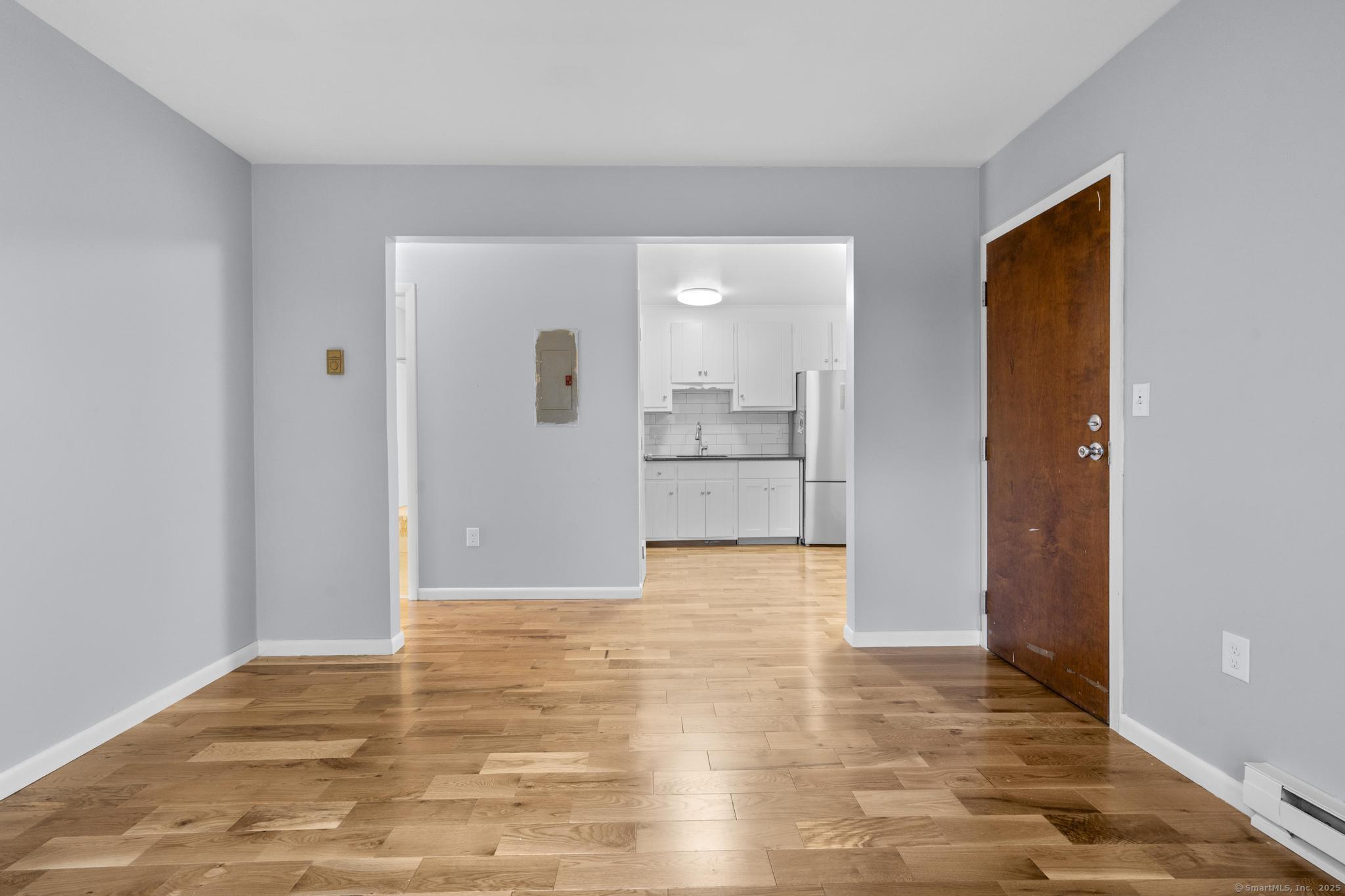 23 Shirley Street, Unit 3 Waterbury, CT 06708 - Photo 3 of 35 a view of empty room with wooden floor