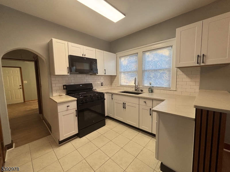 41 Poplar Road Piscataway, NJ 08854 - Photo 11 of 14 a kitchen with a sink cabinets and a window
