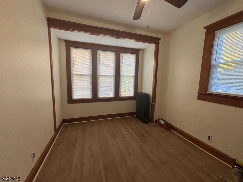 41 Poplar Road Piscataway, NJ 08854 - Photo 8 of 14 an empty room with wooden floor and windows