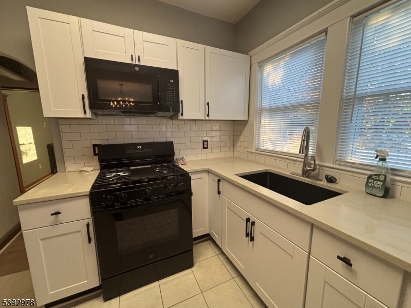 41 Poplar Road Piscataway, NJ 08854 - Photo 10 of 14 a kitchen with a sink stove and microwave