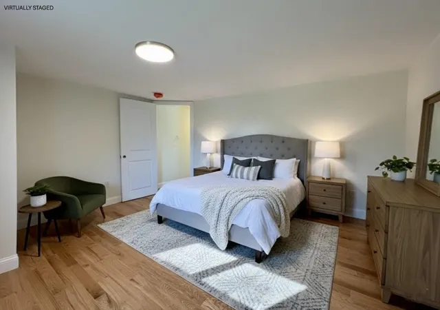 a bedroom with a bed and wooden floor