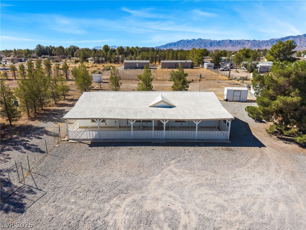 1551 West Wilson Road Pahrump, NV 89048 - Photo 50 of 68 A spacious front porch stretches across this classic home set against a desert mountain backdrop.