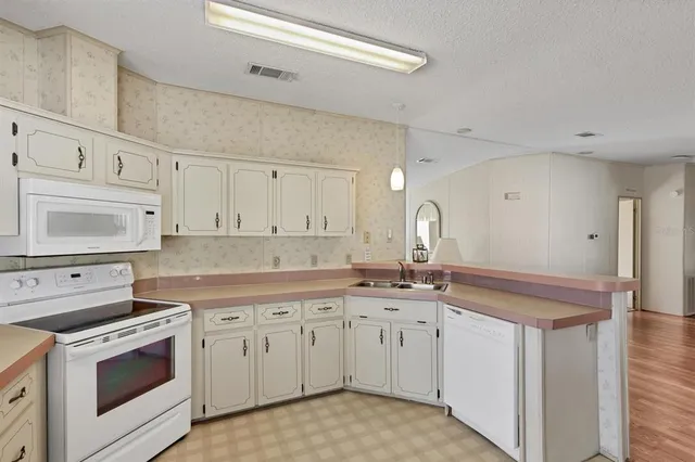 a living room with furniture and a lamp