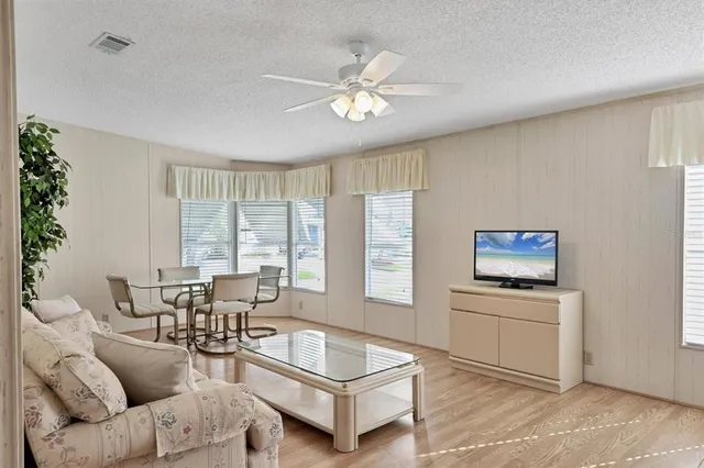 a view of a dining room with furniture and wooden floor