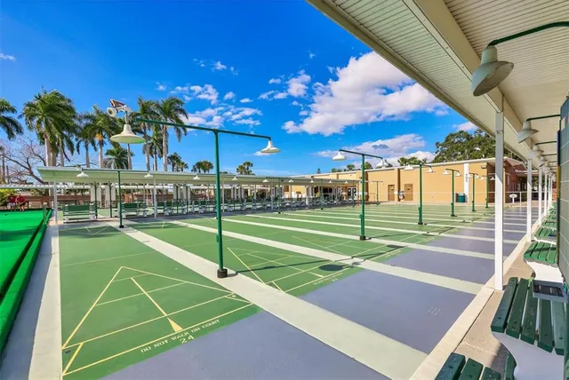 a view of a city with flower plants and wooden fence
